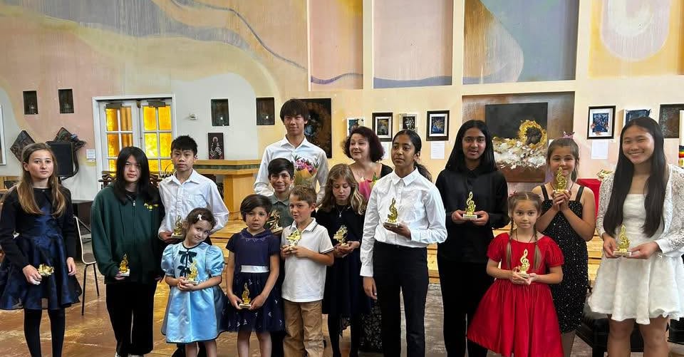 Victoria's students at a recital with trophies
